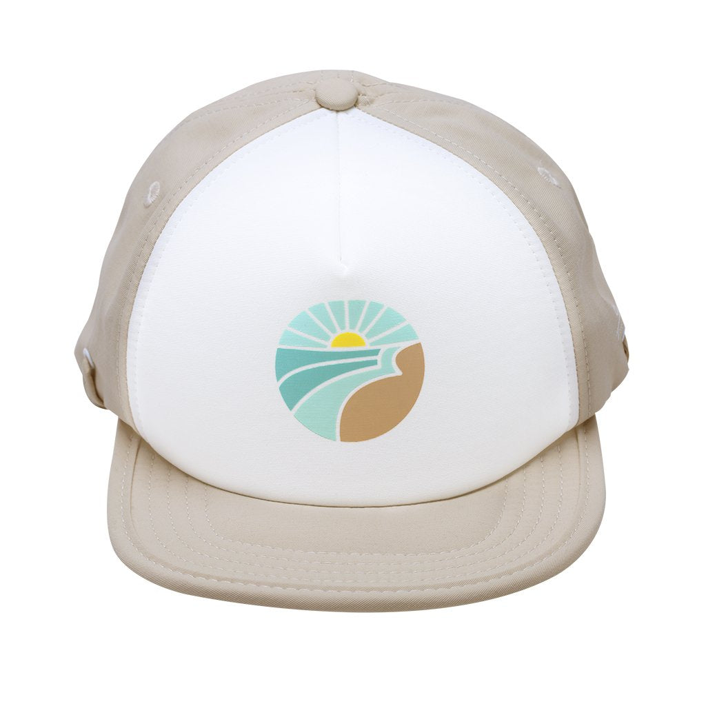 Trucker style hat with nude (beige) back and brim, white front panel with a circular graphic of the sun rising over water by Bitty Brah