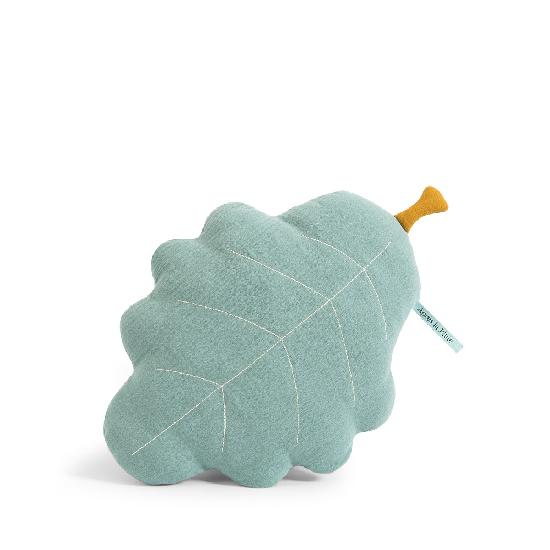 White background with Apres La Pluie Oak Leaf Cushion by Moulin Roty. Cushion is shaped like a leaf and is pale blue, with a yellow stem.