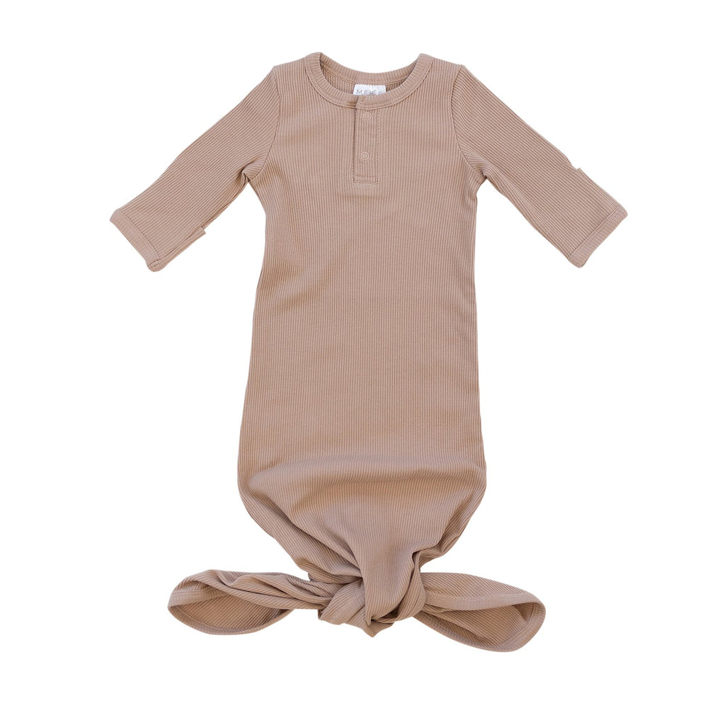 White background with Pale Pink Organic Cotton Ribbed Knot Gown by Mebie Baby. Knot gown is a very pale pink, with 2 buttons down the front, and a knot tie closure at the bottom.