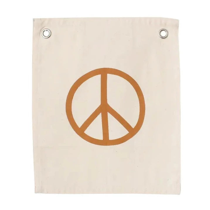 Peace sign in peach on a canvas with metal grommets with a white background. 