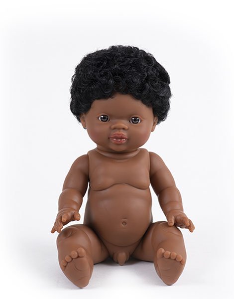 White background with Jaro Doll by Minikane. Jaro is a black male doll with dark eyes, and short dark hair.