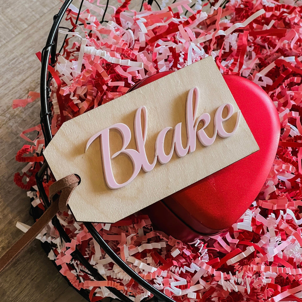 Customized Name Tag by Petit Nordique of the name Blake in Rosette in a Valentine's Day Basket with pink and red decor. 