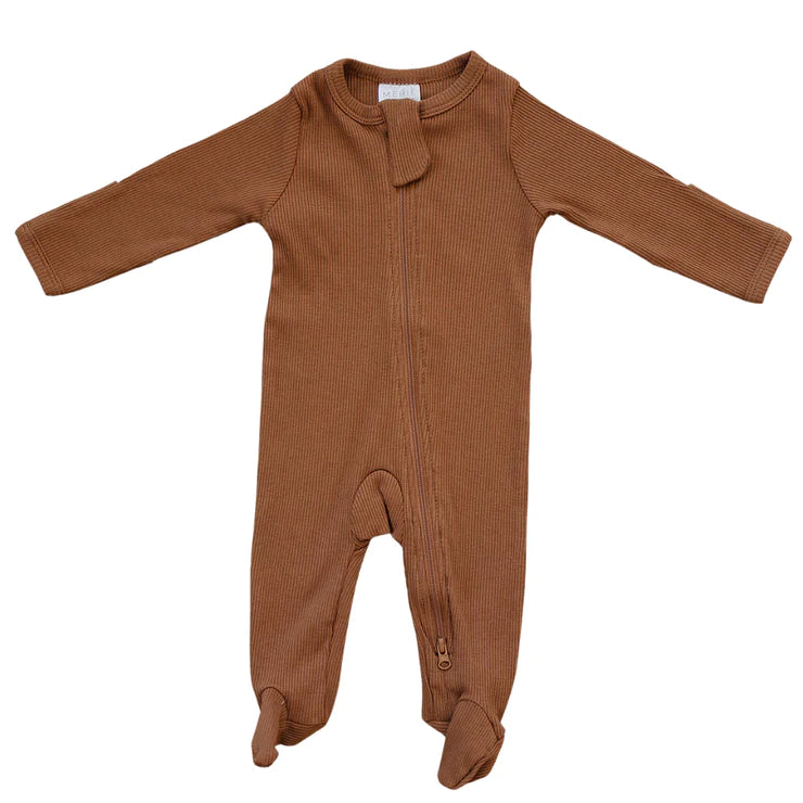 White background with a Rust Organic Cotton Ribbed Zipper One-Piece by Mebie Baby. One piece is rust ribbed, with a zipper all the way down, and footies.
