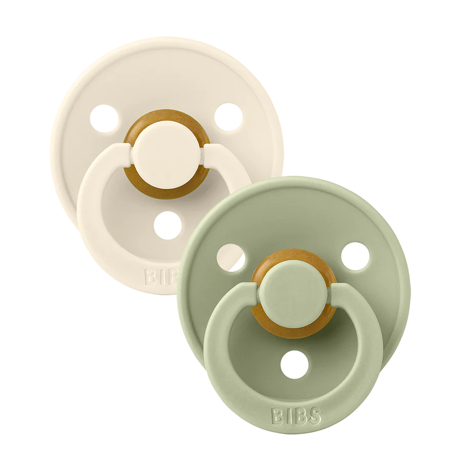 Clear background with the Size 2 Pacifiers in Ivory & Blush by Bibs. Set includes one ivory, and one sage pacifier.