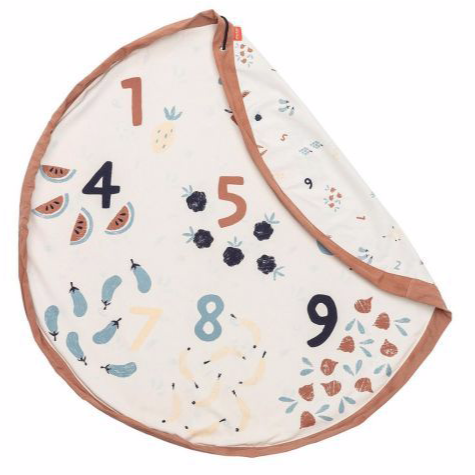 White background with Veggie Number Playmat & Storage Bag by Play & Go. One side is cream with numbers, and veggies & fruit that match the number, and the other side is smaller veggies & numbers.