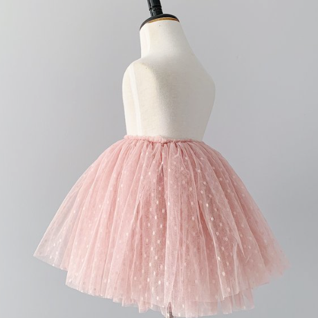 Baby Sophie Tutu in Vintage Rose by Bluish on a mannequin, in front of a grey wall. 