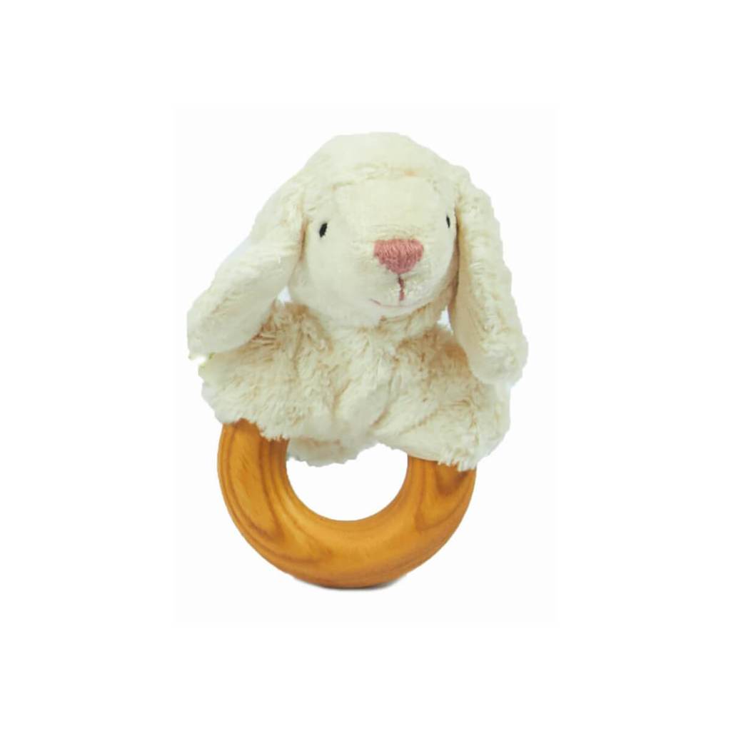 White background with the Animal Rattle in Sheep by Senger Naturwelt. Rattle has a circular wooden handle with a white stuffed sheeps head attached.