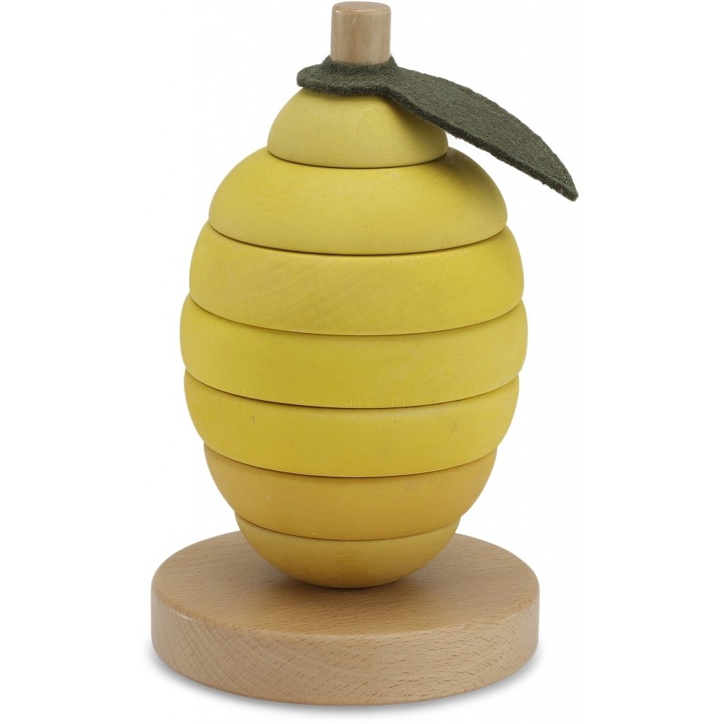 White background with Lemon Stacking Fruit by Konges Slojd. The Lemon Stacking Fruit has a wood base. with a wood pole in the middle, and a yellow lemon that you stack.