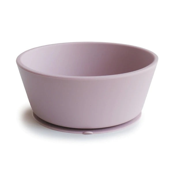 White background with Silicone Suction Bowl in Soft Lilac by Mushie. Bowl has a suction base, and is a pale purple colour.