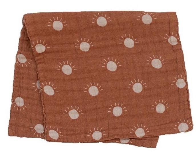 White background with Sunshine Burp Cloth by Mebie Baby folded in half. Burp cloth is orange with white suns all over.