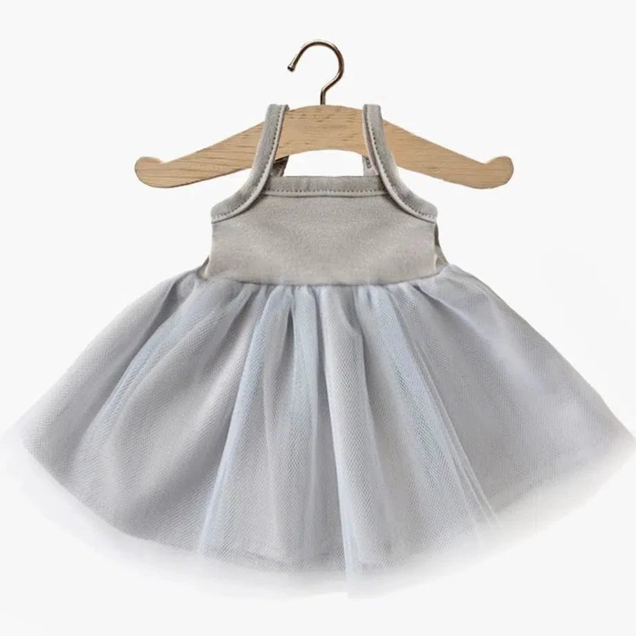 White background with Rosella Tutu For Dolls in Grey by Minikane. Tutu is a grey spaghetti strap top with a grey tulle skirt.
