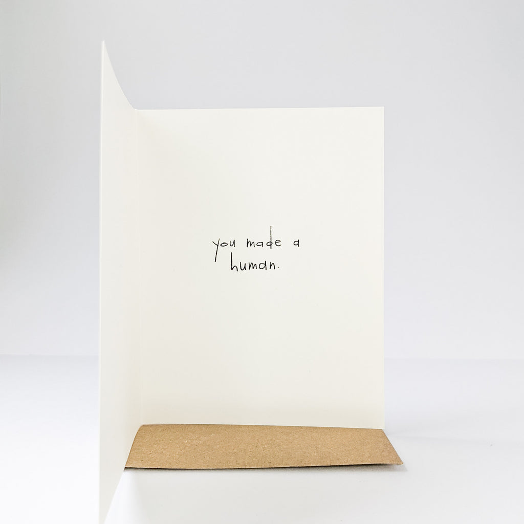 White background showing the inside of the Congrats Card by Under The Stairs Paper Co. The inside says "you made a human".