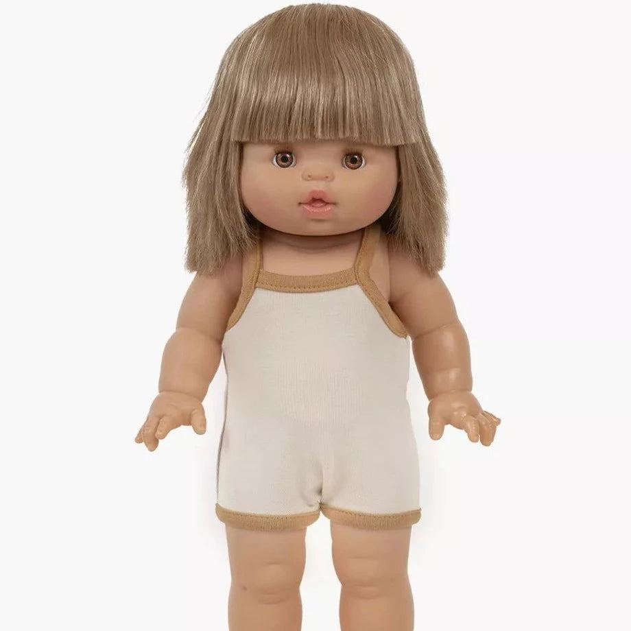 White background with Zoélie Doll by Minikane. Doll has light skin, blonde hair, and brown eyes, and wearing a cream romper.