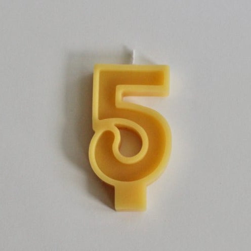 White background with 100% Pure Canadian Beeswax Candle in "5" by Fersk Self Care. Candle is a natural yellow beeswax colour, with the number 5 and a wick on the top