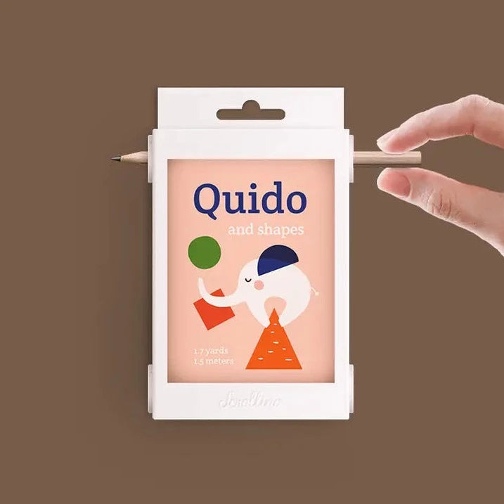 Quido and Shapes game by Scrollino with a hand on a pencil. Brown background. 