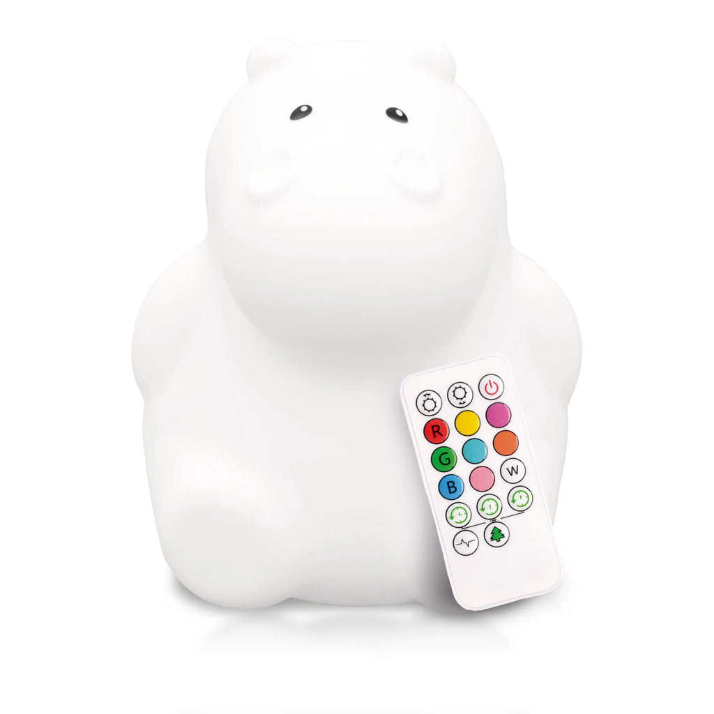 White background with Lumipets® LED Night Light in Hippo by Lumieworld. Hippo is white, with black eyes, and shows the white remote.
