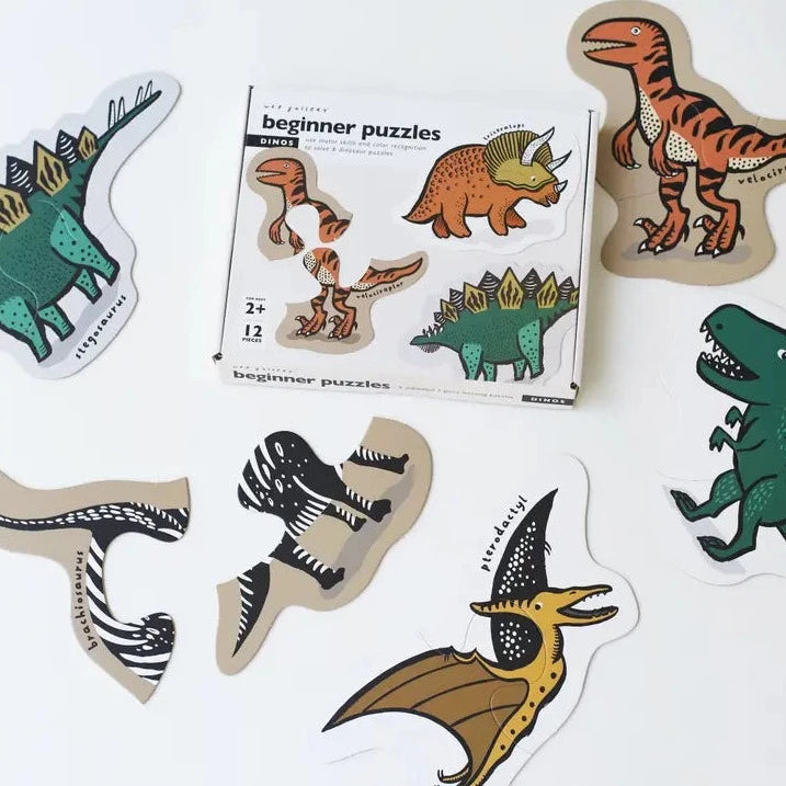 Beginner Puzzles in Dinos by Wee Gallery, with dinos on white surface. 
