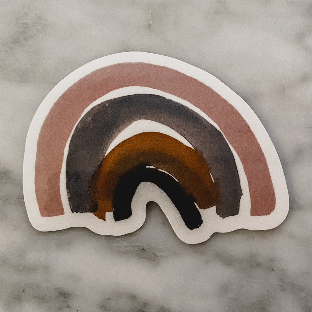 White marble background with the Sticker in Rainbow by The Pine Company. Sticker is of a watercolour rainbow.