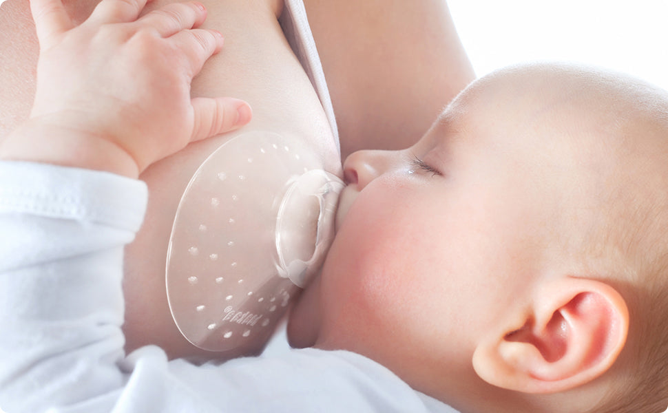 Close up of baby breastfeedind, mama is wearing the Breastfeeding Nipple Shield by Haakaa.