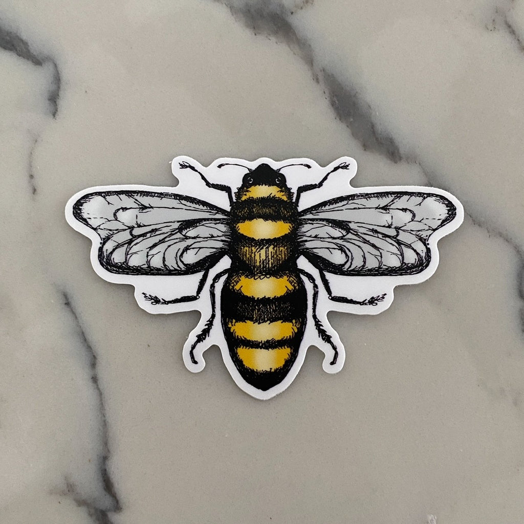 White marble counter with the Sticker in Bee (glossy) by The Pine Company. Sticker is of a big yellow bee.