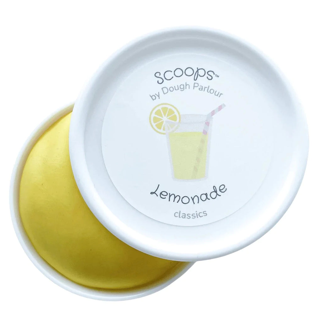 White background with Lemonade Play Dough by Dough Parlour, open slightly to show colour. Play dough comes in a white container, dough is a vibrant yellow, and lid has a sticker that says "Lemonade".