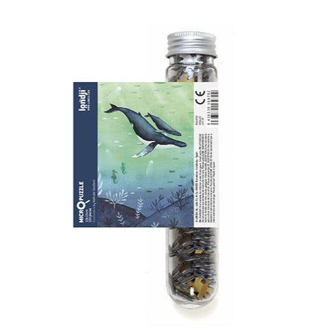 White background with Wildlife Mix Micropuzzle in Whales by Londji. Puzzle comes in a clear tube.
